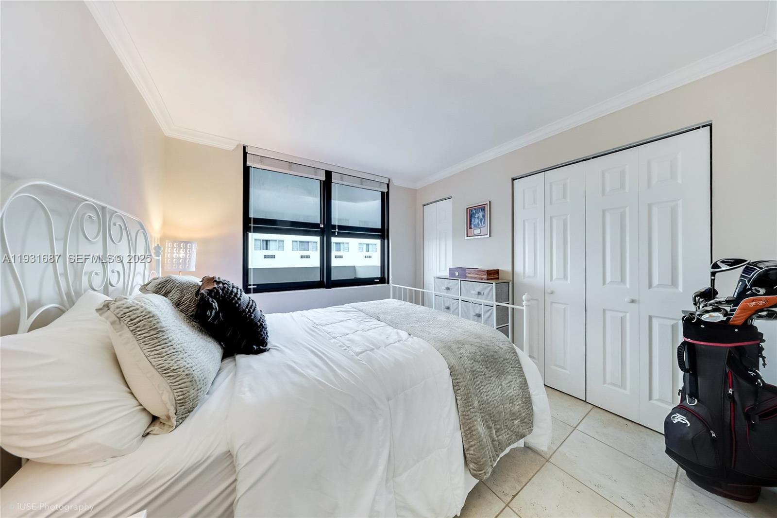 4301 Collins Avenue, Unit 803 Miami Beach, FL 33140 - Photo 20 of 25 a bedroom with a bed and a window