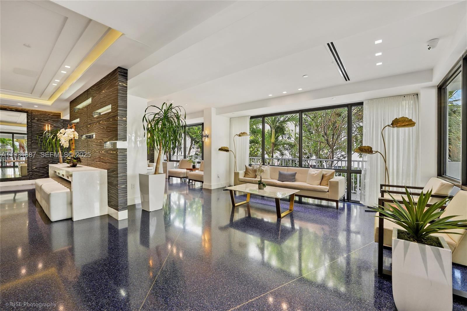 4301 Collins Avenue, Unit 803 Miami Beach, FL 33140 - Photo 4 of 25 a living room with fireplace furniture and a large window