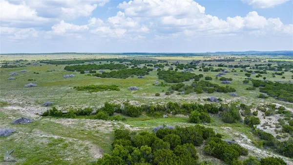 a view of a field with an ocean view