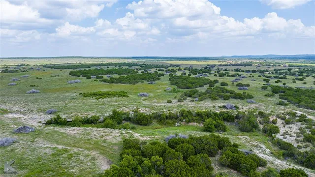 a view of a field with an ocean view