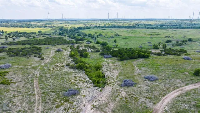 a view of a field with an ocean view