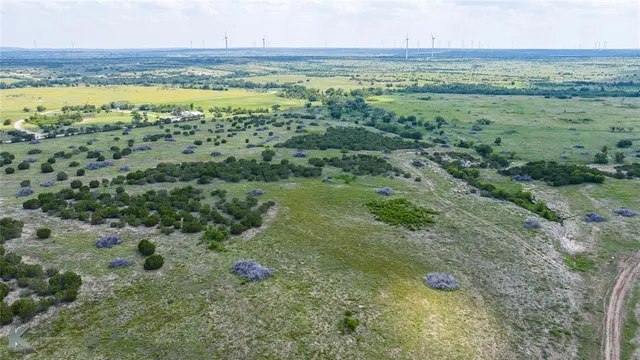 a backyard of a house with table and chairs a fire pit