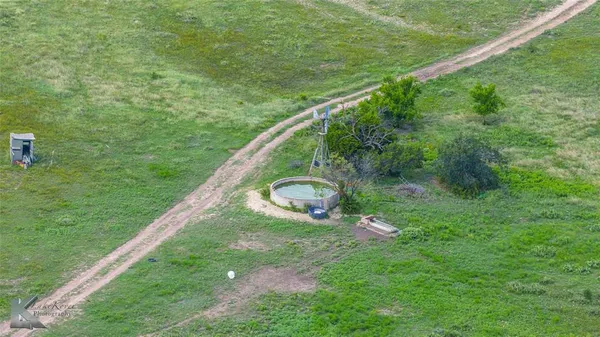 a view of a field with an ocean