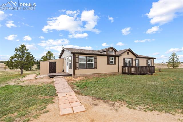 17315 Hopper Road Peyton, CO 80831 - Photo 18 of 20 Steps to kitchen entry way, patio, and shed on lefthand side of the house