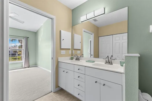 a bathroom with a double vanity sink and mirror