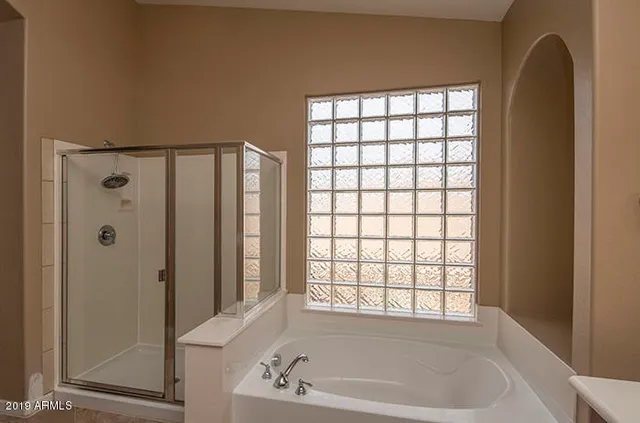 a bathroom with a bathtub and a shower