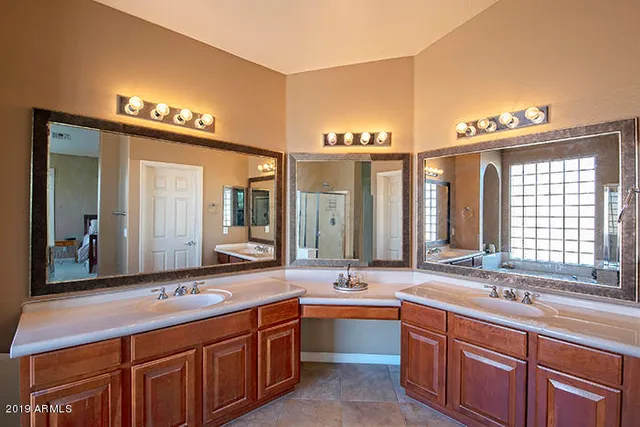 a bathroom with a sink double vanity and a large mirror