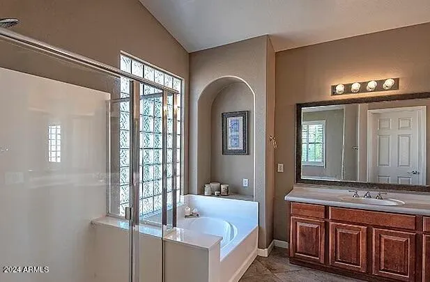 a en suite bathroom with a tub and a large mirror