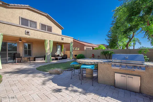 a view of a chairs and table in backyard of the house