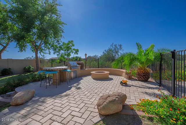 a view of a patio with table and chairs potted plants with wooden fence