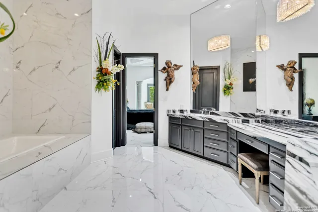 a bathroom with a tub sink and mirror