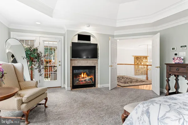 a living room with stainless steel appliances furniture a rug and a flat screen tv