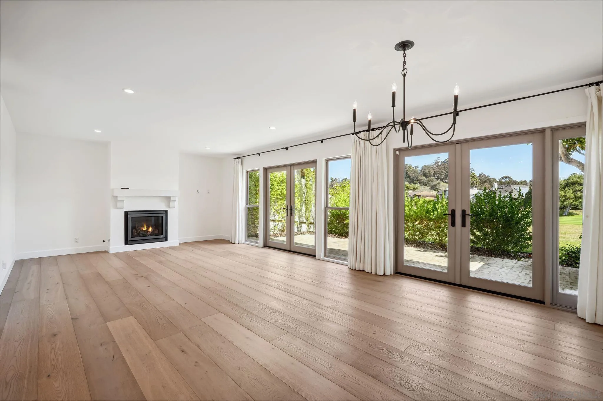211 Via Osuna Rancho Santa Fe, CA 92091 - Photo 11 of 32 a view of empty room with wooden floor and fireplace