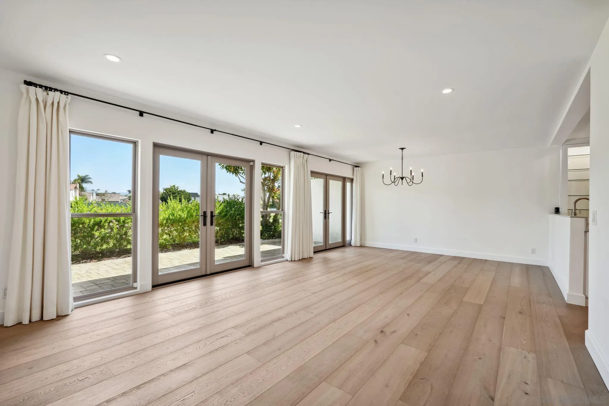 211 Via Osuna Rancho Santa Fe, CA 92091 - Photo 12 of 32 a view of an empty room with wooden floor and a window