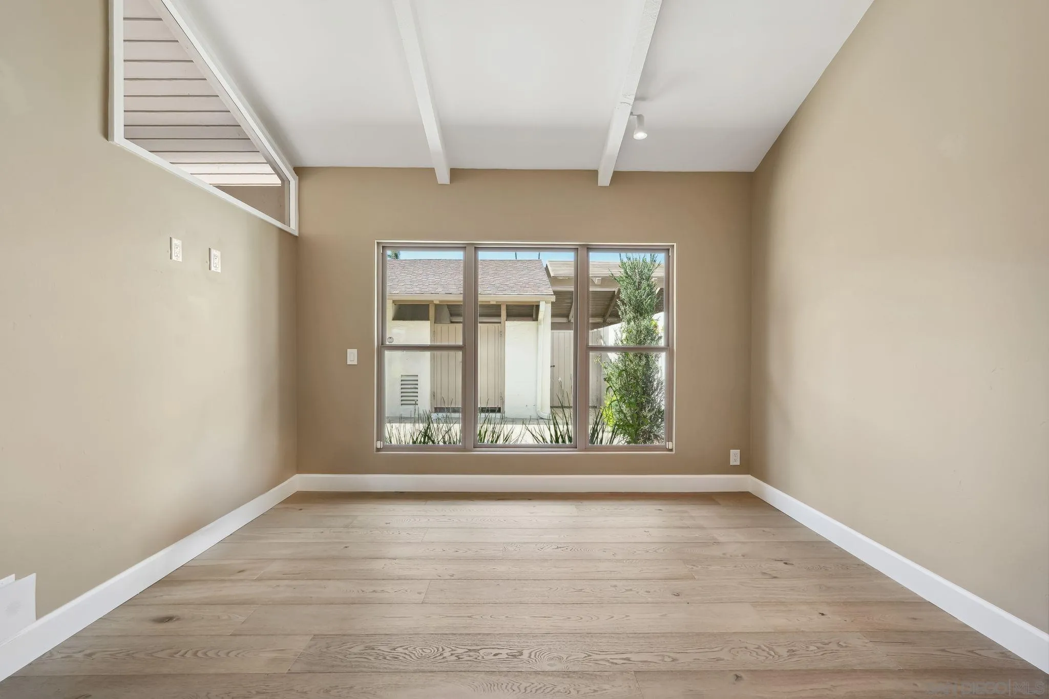 211 Via Osuna Rancho Santa Fe, CA 92091 - Photo 18 of 32 an empty room with wooden floor and windows