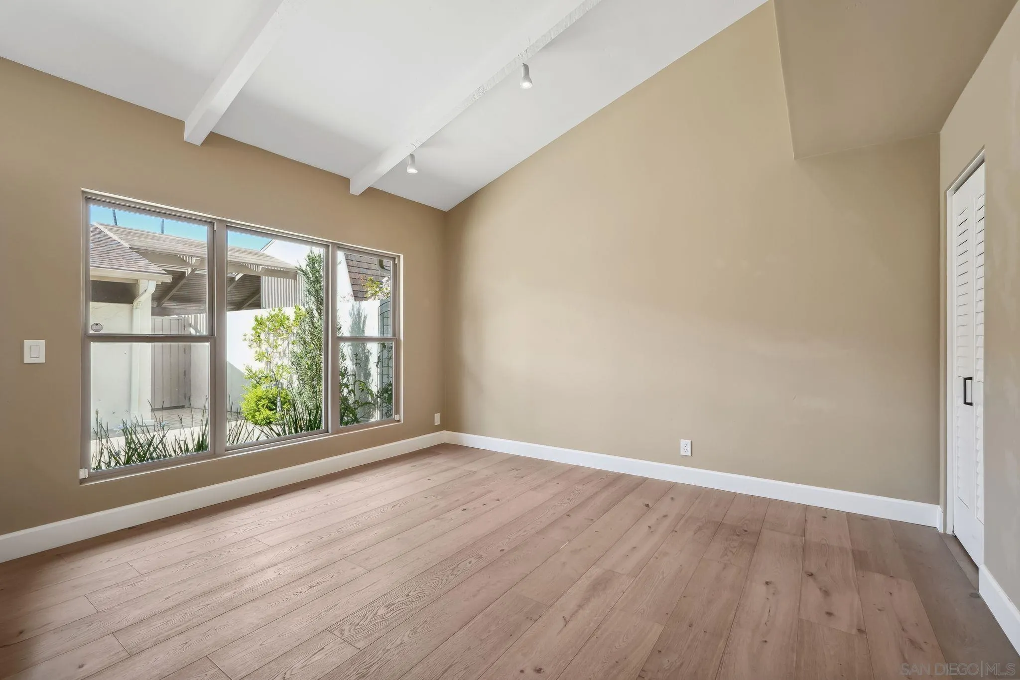 211 Via Osuna Rancho Santa Fe, CA 92091 - Photo 19 of 32 a view of an empty room with wooden floor and a window