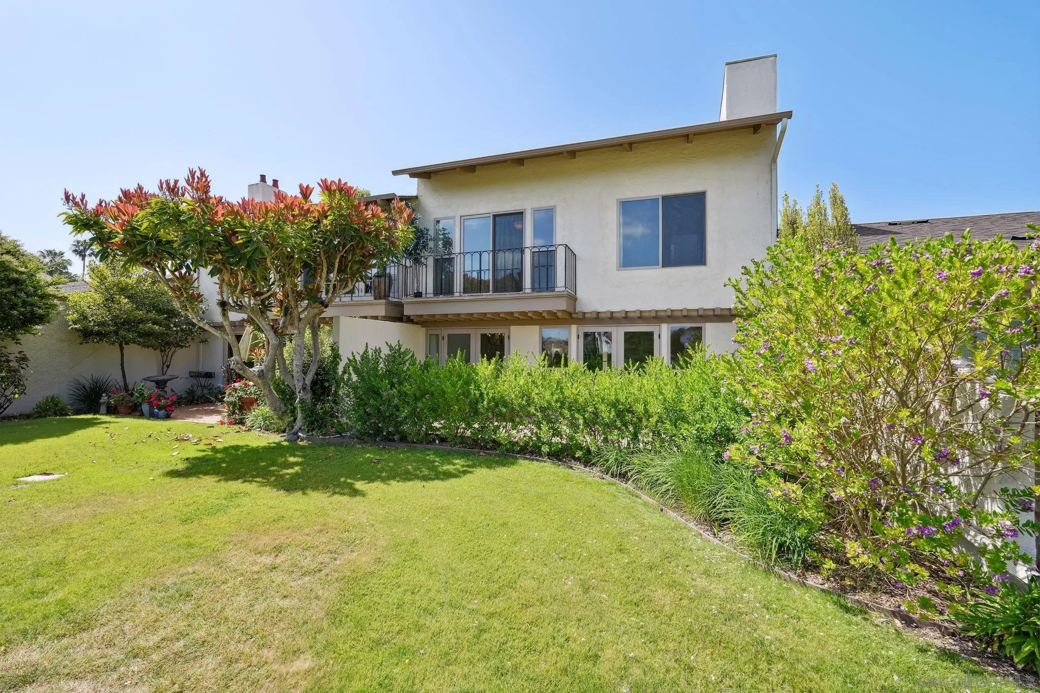 211 Via Osuna Rancho Santa Fe, CA 92091 - Photo 29 of 32 a front view of a house with a big yard and a large tree