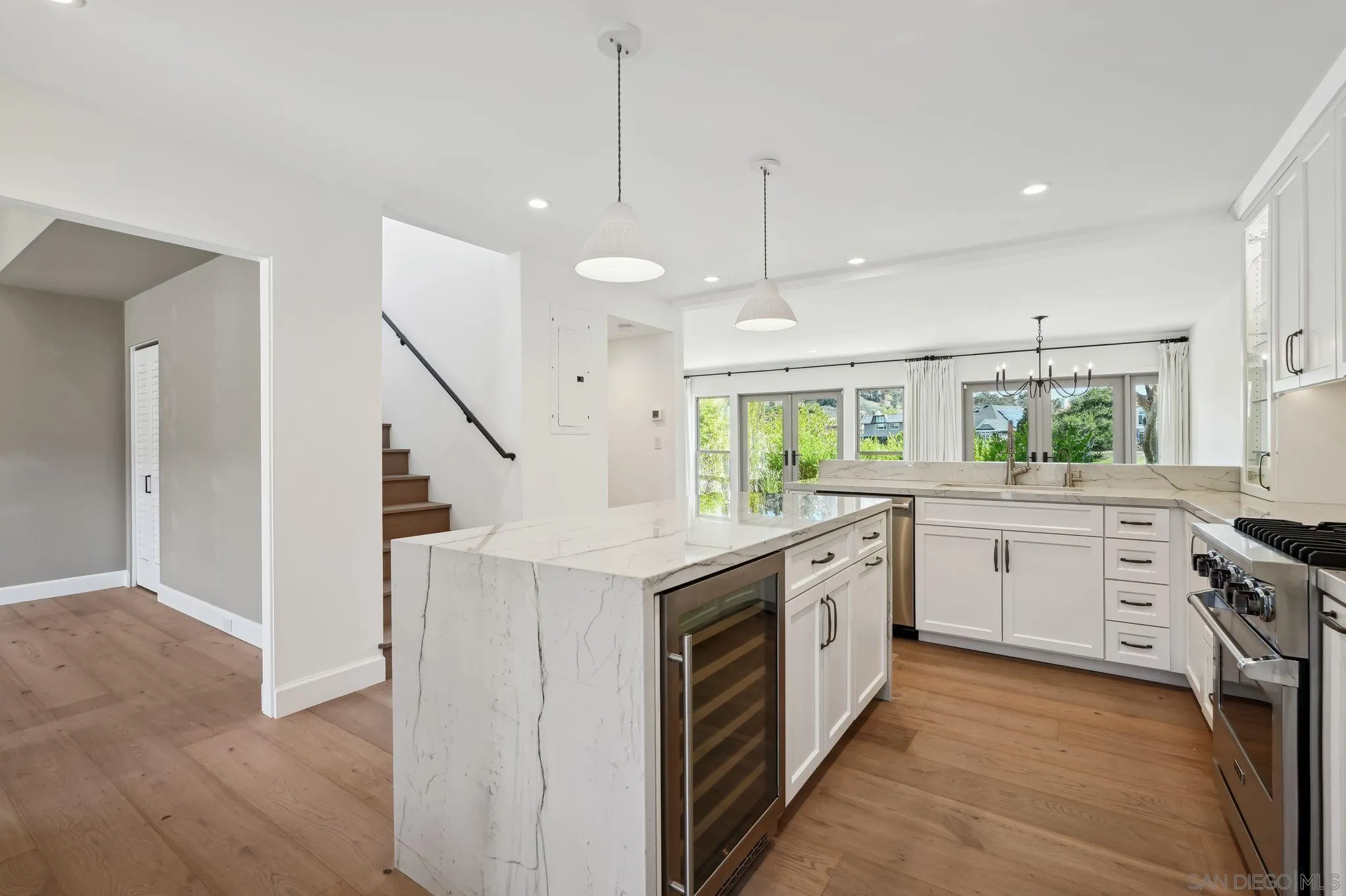 211 Via Osuna Rancho Santa Fe, CA 92091 - Photo 7 of 32 a kitchen with granite countertop a white stove top oven and white cabinets