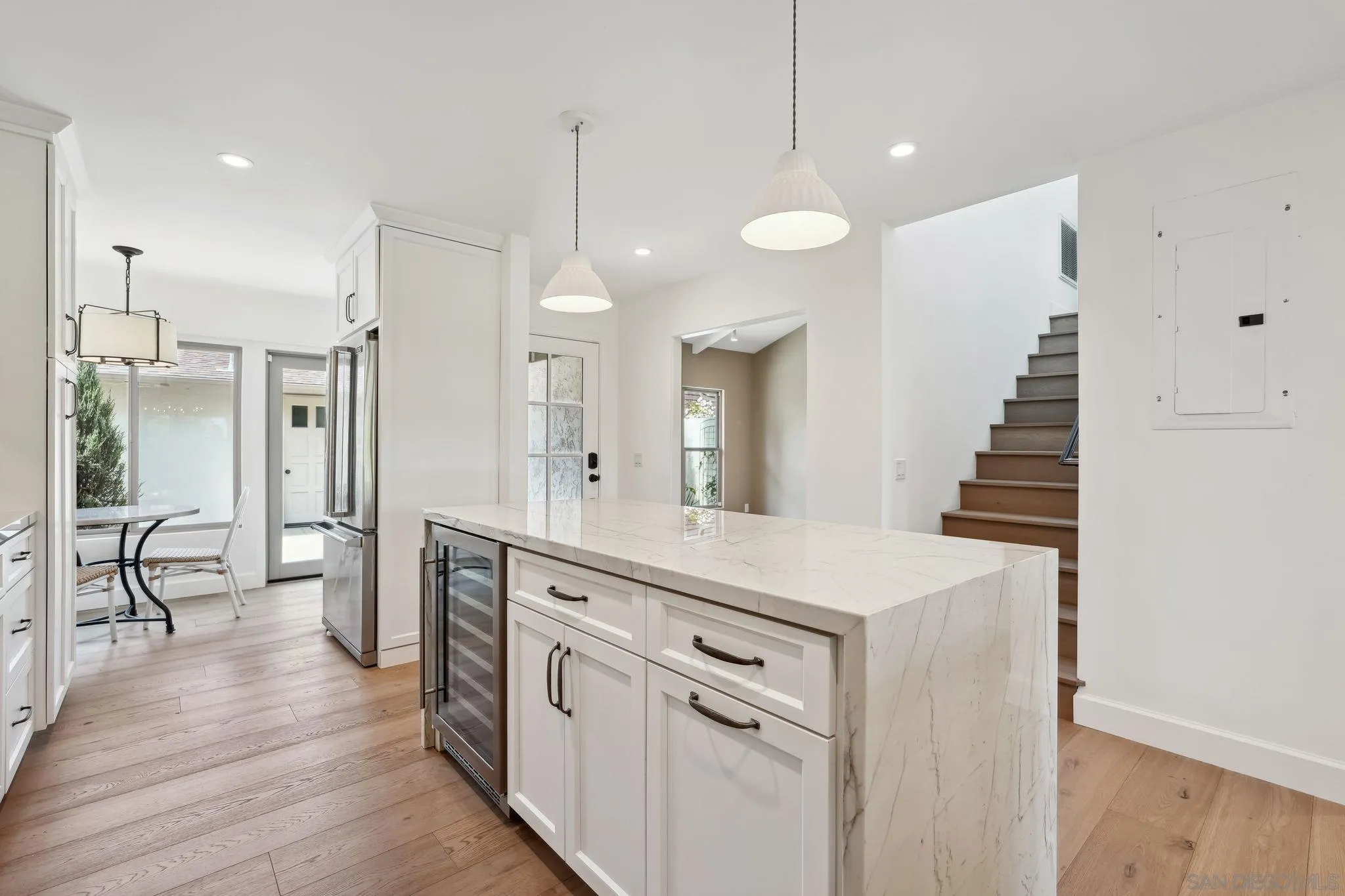 211 Via Osuna Rancho Santa Fe, CA 92091 - Photo 8 of 32 a open kitchen with white cabinets and stainless steel appliances