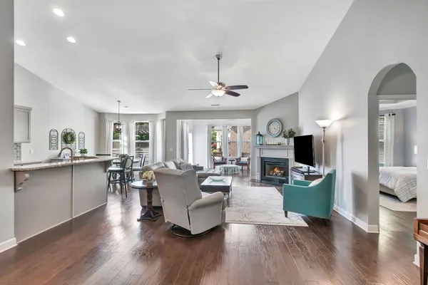a living room with fireplace furniture and a wooden floor