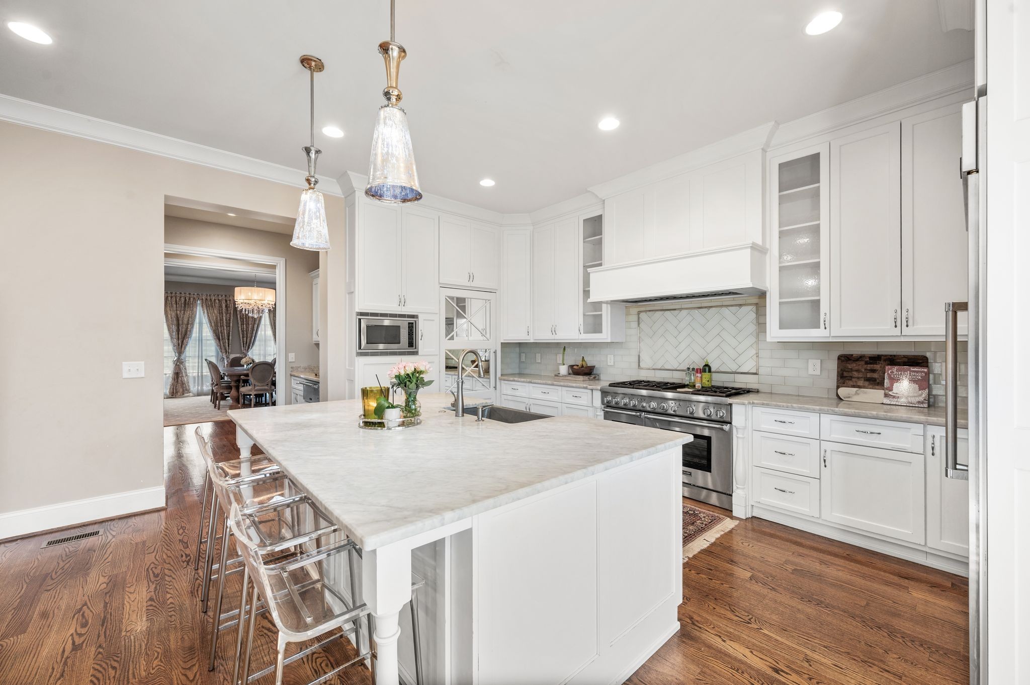 3509 Trimble Road Nashville, TN 37215 - Photo 27 of 80 a kitchen that has a lot of cabinets in it with stainless steel appliances granite countertop a stove a sink a refrigerator and white cabinets with wooden floor