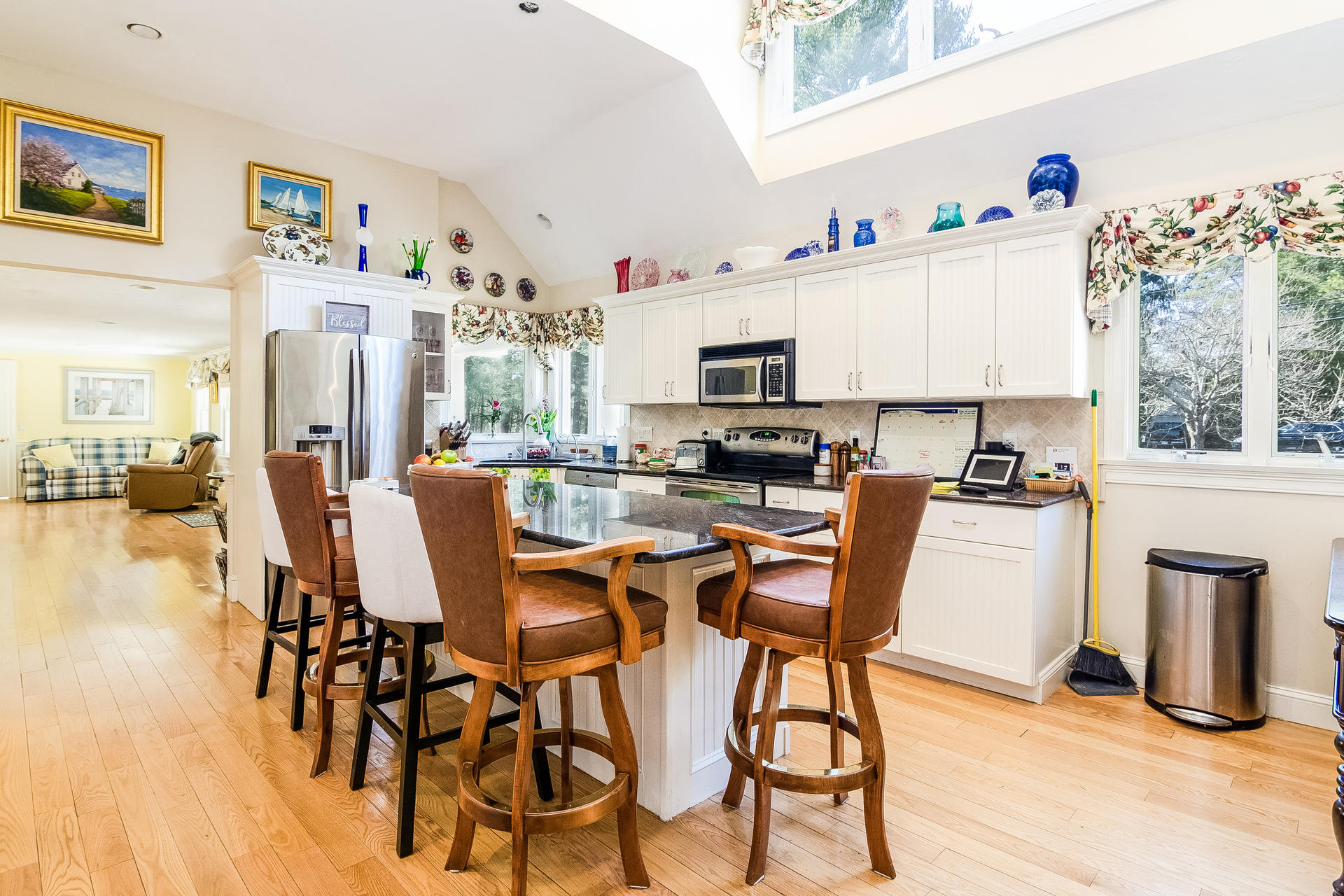568 Santuit Road Cotuit, MA 02635 - Photo 12 of 30 a kitchen with stainless steel appliances a table and chairs in it