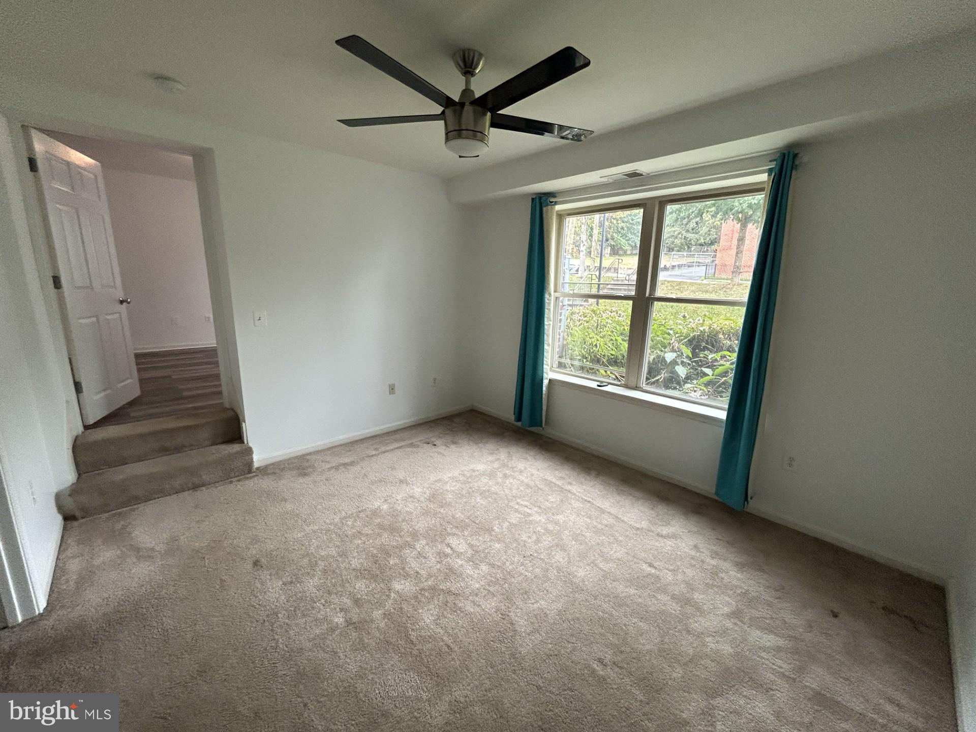 1700 W Street Southeast, Unit 5 Washington, DC 20020 - Photo 11 of 15 an empty room with windows and ceiling fan