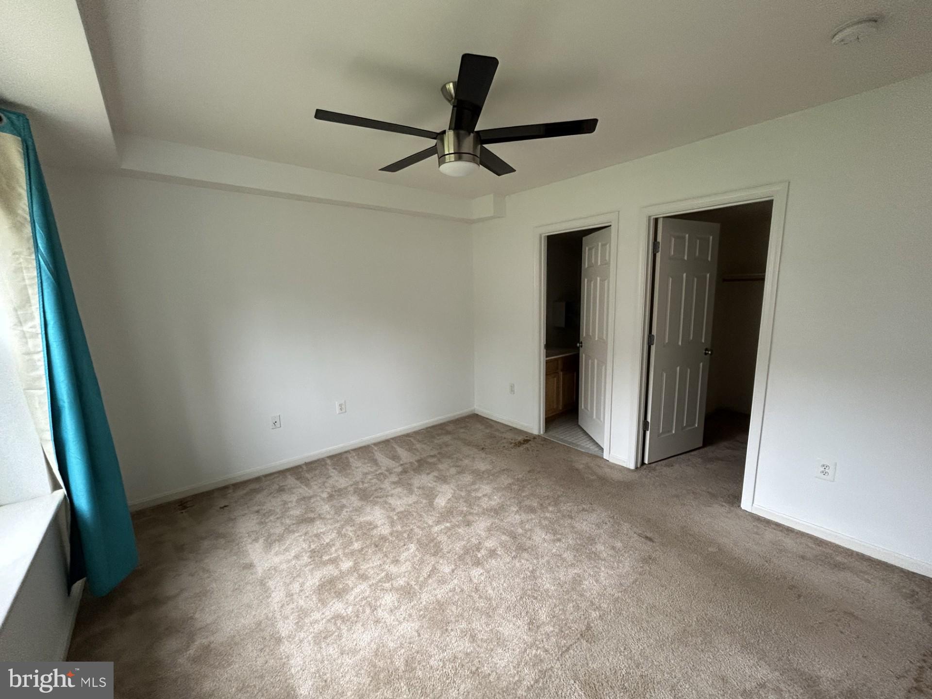 1700 W Street Southeast, Unit 5 Washington, DC 20020 - Photo 10 of 15 an empty room with ceiling fan and window