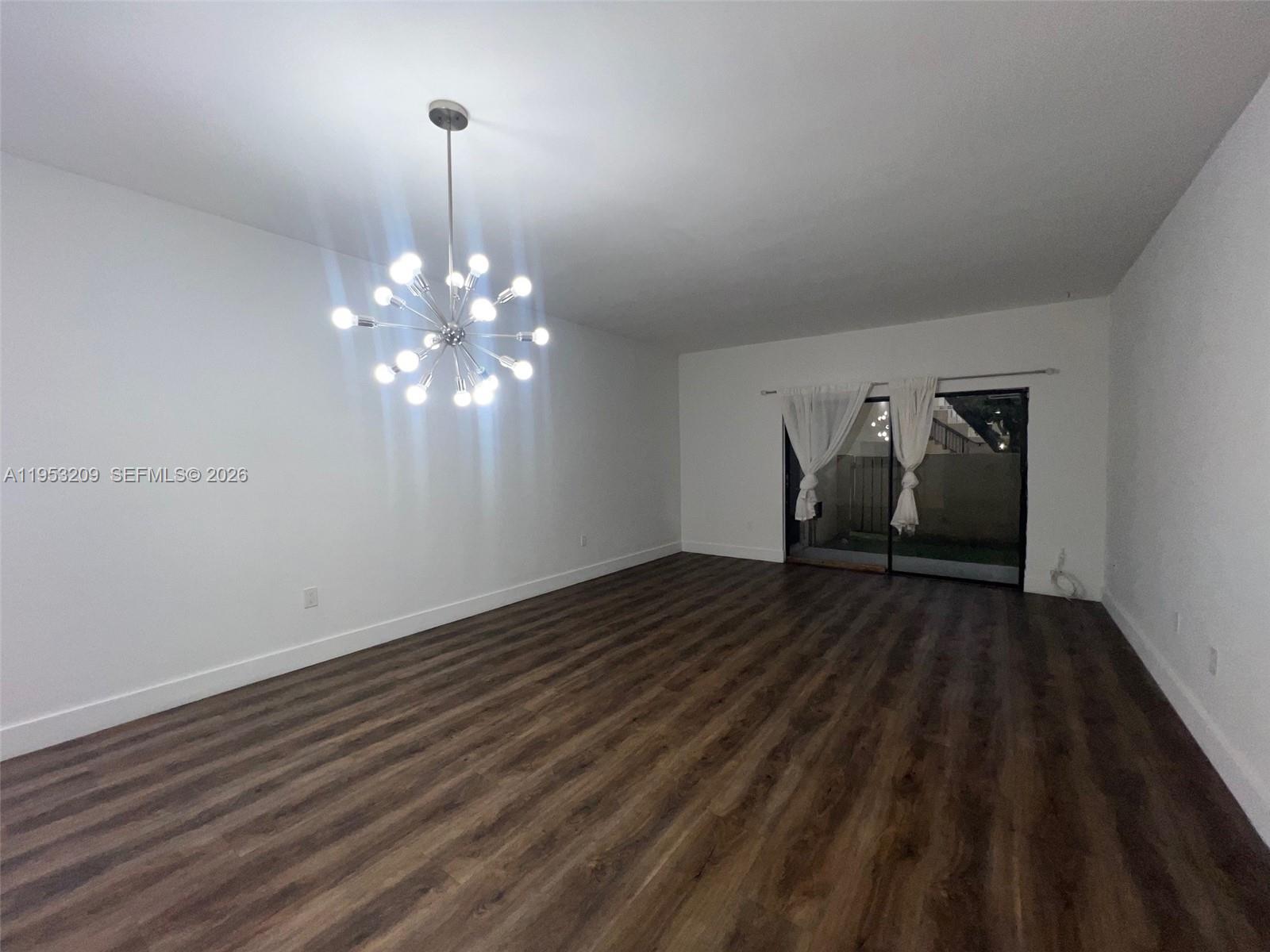 8831 Southwest 130th Place, Unit 106 Miami, FL 33186 - Photo 2 of 15 a view of a livingroom with wooden floor