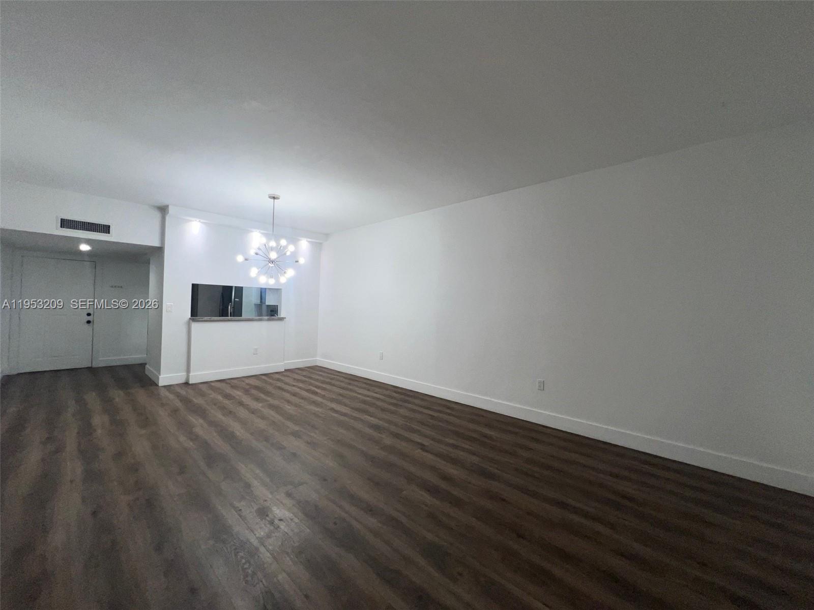 8831 Southwest 130th Place, Unit 106 Miami, FL 33186 - Photo 4 of 15 wooden floor in an empty room