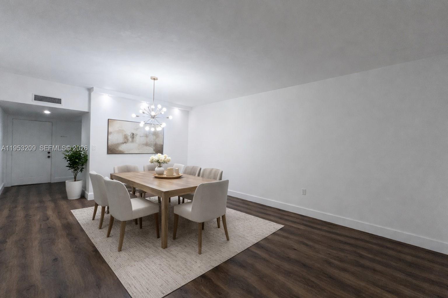 8831 Southwest 130th Place, Unit 106 Miami, FL 33186 - Photo 5 of 15 a view of a dining room with furniture and wooden floor