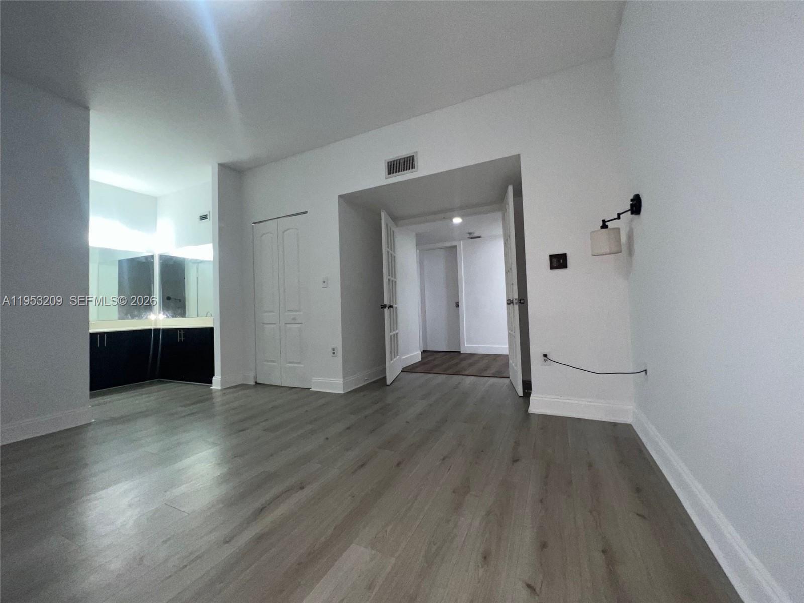 8831 Southwest 130th Place, Unit 106 Miami, FL 33186 - Photo 9 of 15 wooden floor in an empty room