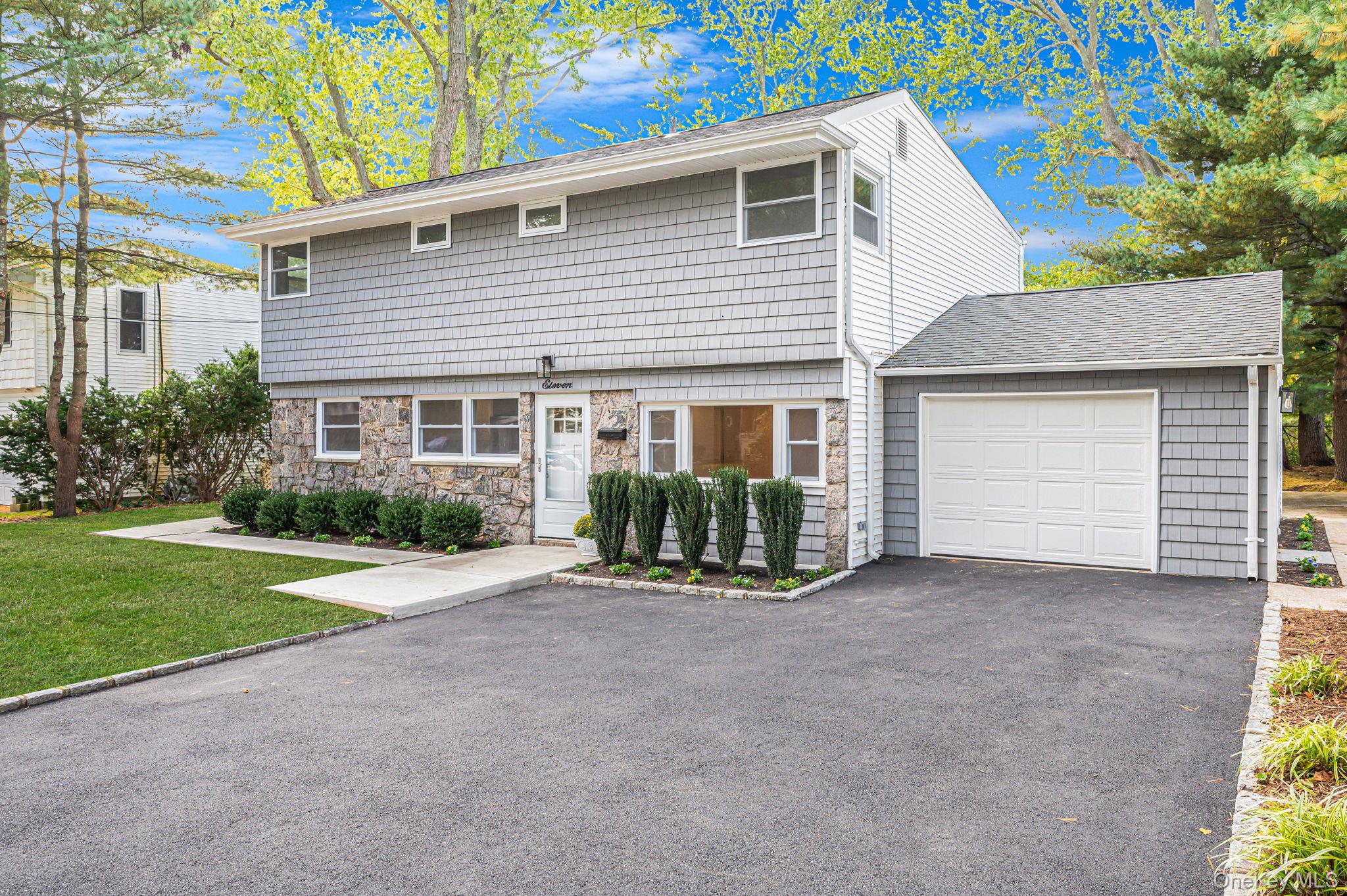 11 Lucille Lane Commack, NY 11725 - Photo 1 of 1 a view of a house with a yard and garage
