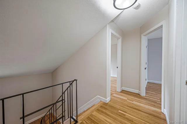 a view of a room with wooden floor and white walls