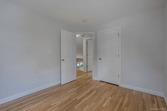 a view of an empty room and wooden floor