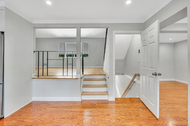 a view of entryway and hall with wooden floor
