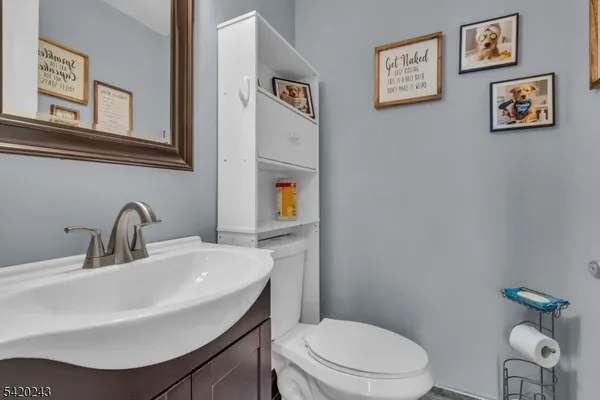 a bedroom with a bed chandelier and a window