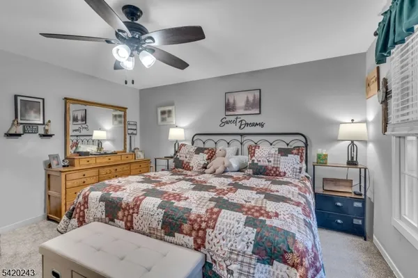 a bathroom with a granite countertop sink a toilet and a mirror