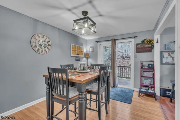 a view of a dining room with furniture wooden floor and a chandelier