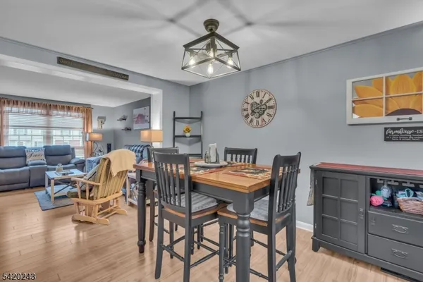 a view of a dining room with furniture and a chandelier