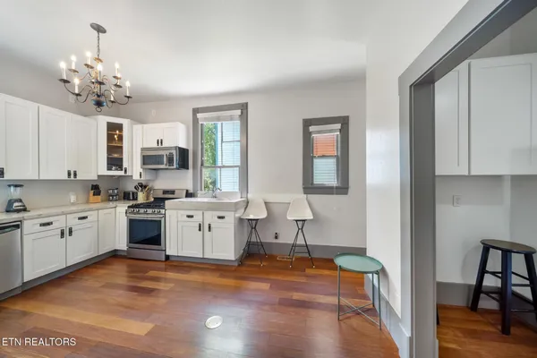 a large white kitchen with cabinets