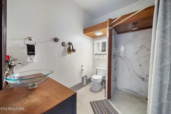 a bathroom with a sink toilet and shower