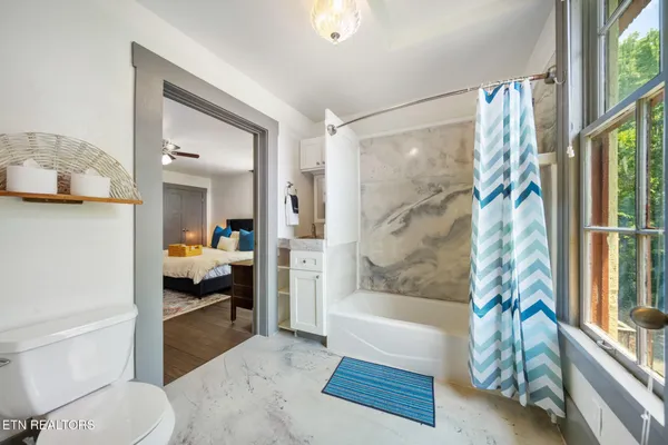 a bedroom with a bed and a large window