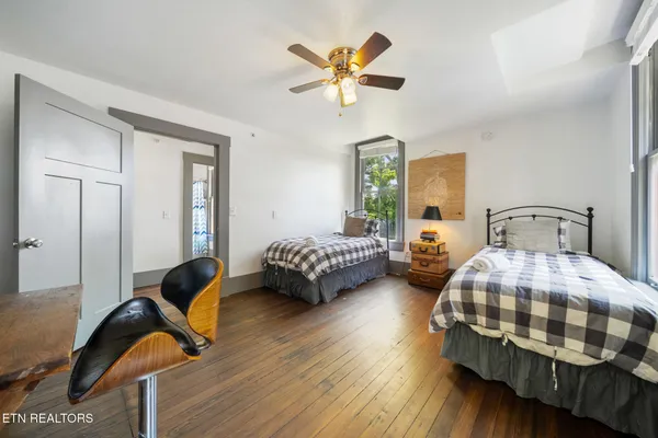 a bedroom with a bed and a large window