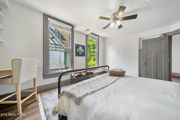 a bedroom with a bed and a painting on the wall