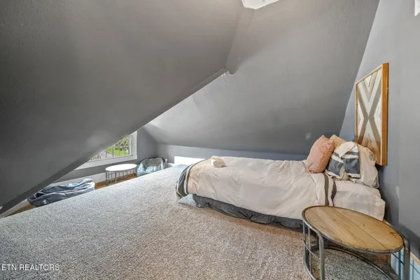 a bedroom with a bed and a large window