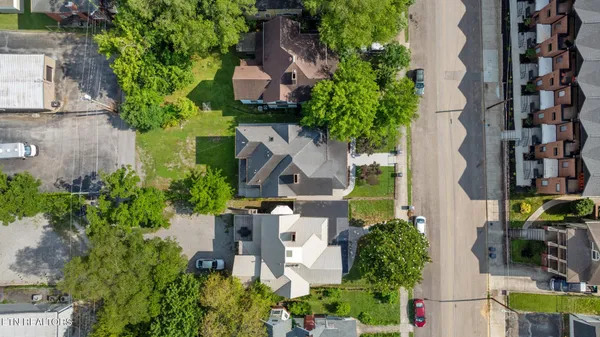 an aerial view of multiple houses with yard