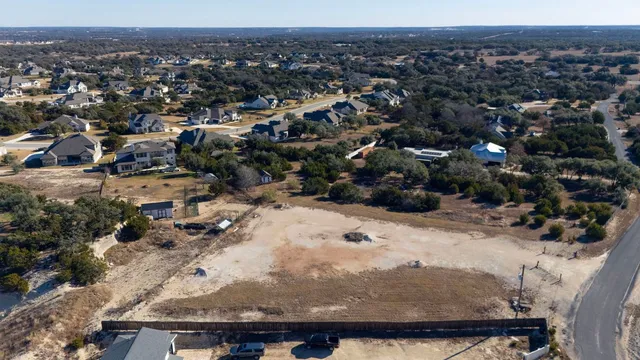 an aerial view of a house with a yard and garden