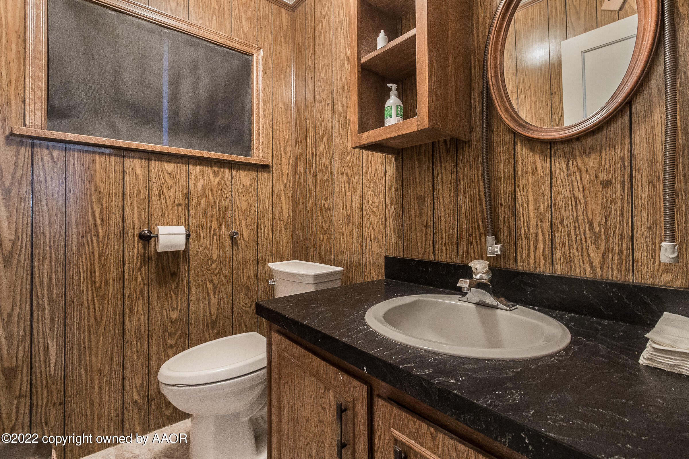 1601 South Austin Street Amarillo, TX 79102 - Photo 36 of 46 a bathroom with a sink a toilet and a mirror