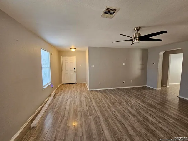 wooden floor in an empty room with a window
